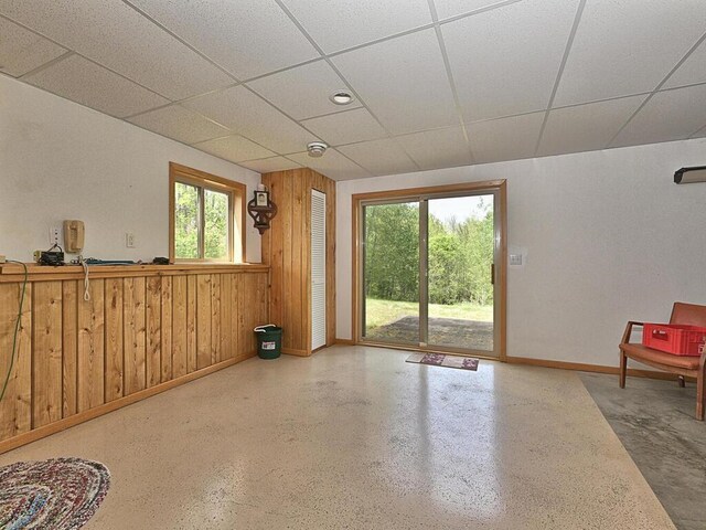 38850 Christie Ln, Cohasset, MN 55721 - spare room with baseboards, a paneled ceiling, and wooden walls