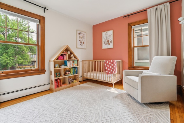 1014 Fairmount Ave, Saint Paul, MN 55105 - bedroom featuring baseboard heating and wood finished floors