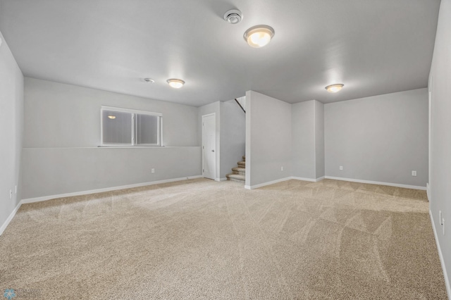 basement with stairs, carpet, and baseboards