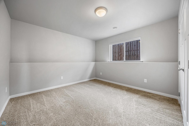 carpeted empty room with baseboards
