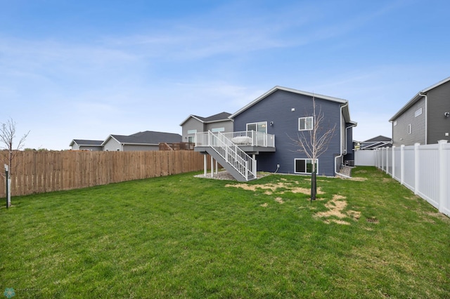 rear view of house featuring stairs and a wooden deck