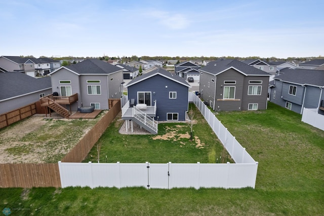 back of property with a residential view, a wooden deck, and stairs