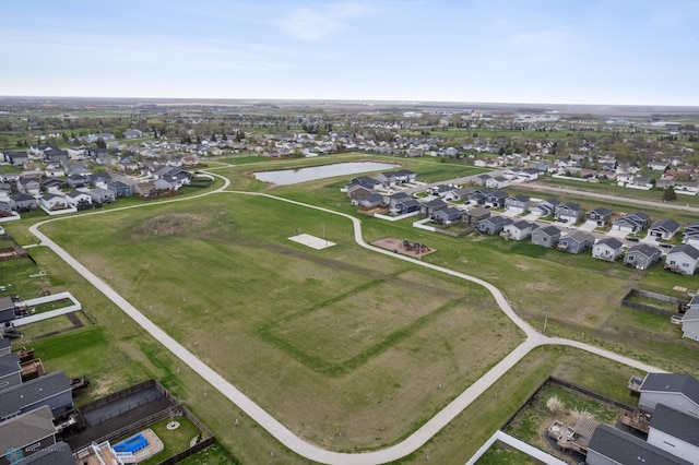 aerial view of property's location with nearby suburban area and a nearby body of water