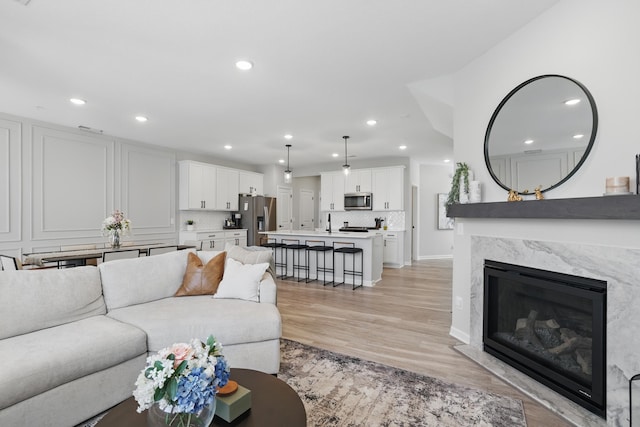 192 Junco Rd N, Lake Elmo, MN 55042 - living room with light wood finished floors, recessed lighting, and a premium fireplace
