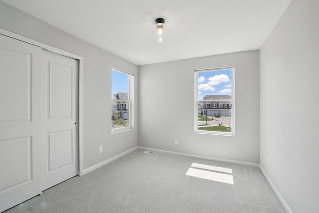 192 Junco Rd N, Lake Elmo, MN 55042 - unfurnished bedroom with carpet flooring, baseboards, and a closet