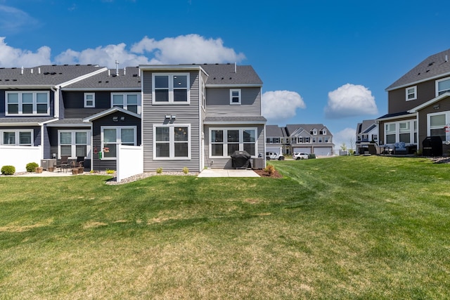 192 Junco Rd N, Lake Elmo, MN 55042 - back of house with a patio area, a residential view, a lawn, and roof with shingles