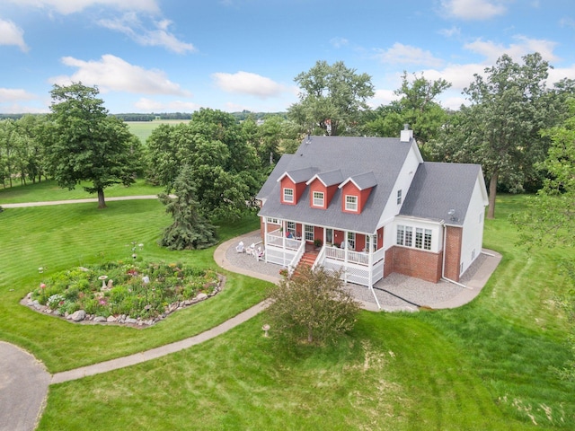 5225 Upland Ave, New Germany, MN 55367 - back of house featuring covered porch, brick siding, a lawn, a chimney, and view of wooded area