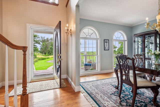 5225 Upland Ave, New Germany, MN 55367 - entryway featuring light wood-style flooring, a chandelier, crown molding, and baseboards