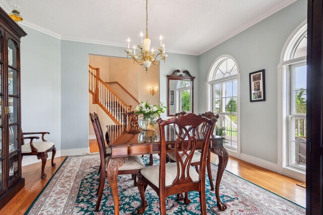 5225 Upland Ave, New Germany, MN 55367 - dining area with a chandelier, ornamental molding, baseboards, light wood-style flooring, and stairs