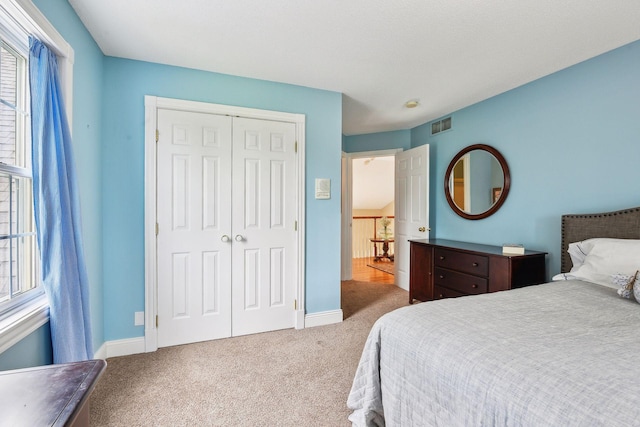 5225 Upland Ave, New Germany, MN 55367 - carpeted bedroom featuring a closet, multiple windows, and baseboards