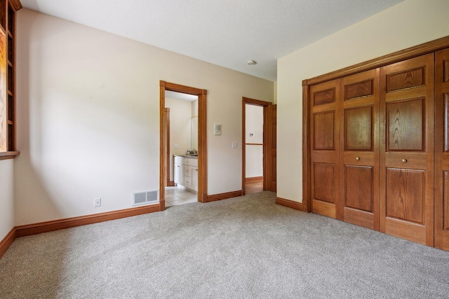 5225 Upland Ave, New Germany, MN 55367 - unfurnished bedroom with light carpet, a closet, baseboards, and ensuite bath