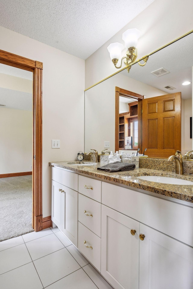 5225 Upland Ave, New Germany, MN 55367 - bathroom featuring a chandelier, double vanity, a textured ceiling, and tile patterned flooring