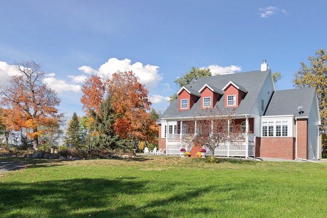 5225 Upland Ave, New Germany, MN 55367 - new england style home featuring a porch, a front lawn, brick siding, and a chimney