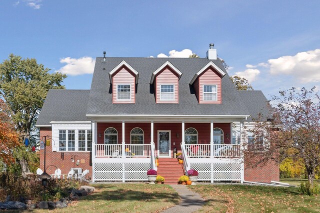5225 Upland Ave, New Germany, MN 55367 - new england style home featuring a porch, a front yard, roof with shingles, and stairway
