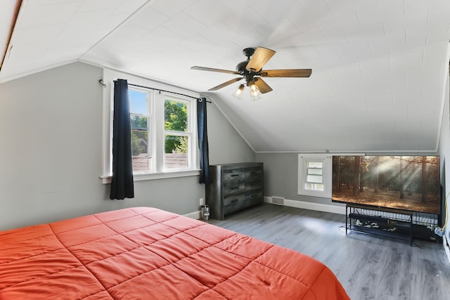 3519 Upton Ave N, Minneapolis, MN 55412 - bedroom with multiple windows, vaulted ceiling, wood finished floors, baseboards, and ceiling fan