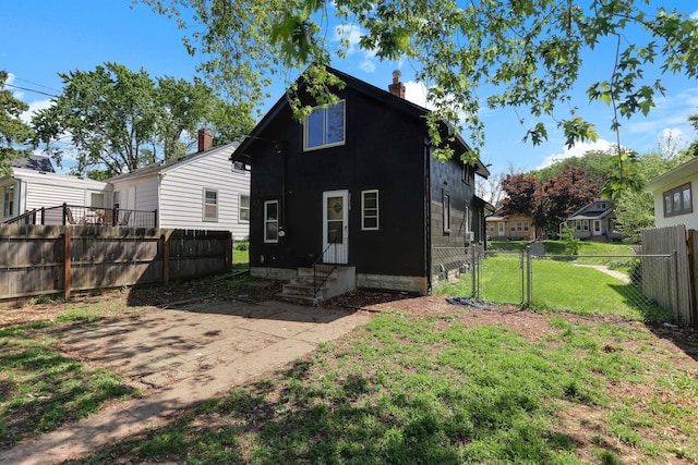 3519 Upton Ave N, Minneapolis, MN 55412 - rear view of property featuring a gate, entry steps, and a chimney