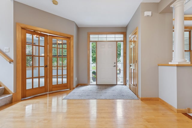 1376 Cobblestone Rd N, Champlin, MN 55316 - foyer entrance featuring wood finished floors, stairs, ornate columns, and french doors