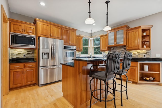 1376 Cobblestone Rd N, Champlin, MN 55316 - kitchen with appliances with stainless steel finishes, open shelves, light wood-type flooring, brown cabinetry, and recessed lighting