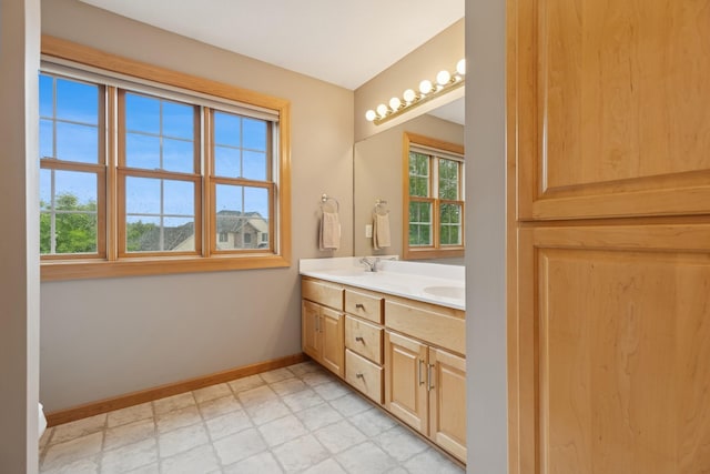 1376 Cobblestone Rd N, Champlin, MN 55316 - bathroom with double vanity and baseboards