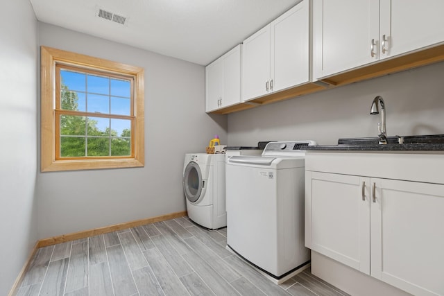 1376 Cobblestone Rd N, Champlin, MN 55316 - laundry area featuring cabinet space, separate washer and dryer, and wood finish floors