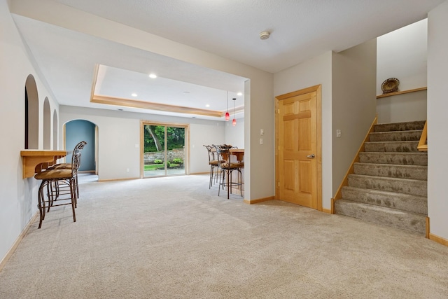 1376 Cobblestone Rd N, Champlin, MN 55316 - empty room featuring arched walkways, carpet floors, stairs, a smoke detector, and recessed lighting