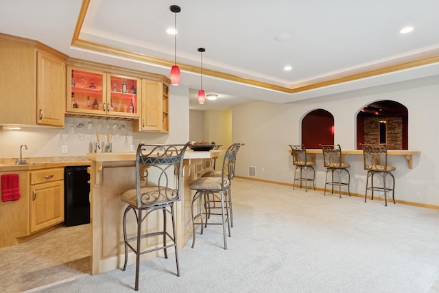 1376 Cobblestone Rd N, Champlin, MN 55316 - kitchen featuring a breakfast bar, a raised ceiling, light brown cabinetry, light colored carpet, and recessed lighting