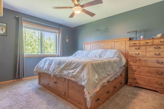 bedroom with light carpet, a ceiling fan, and baseboards