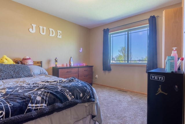 bedroom with carpet floors and baseboards