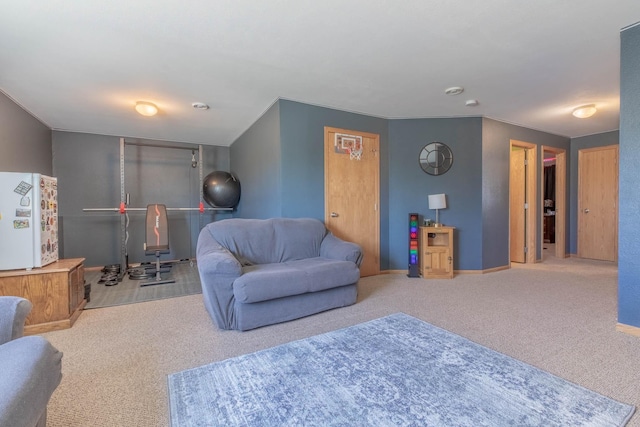 living area featuring carpet flooring and baseboards
