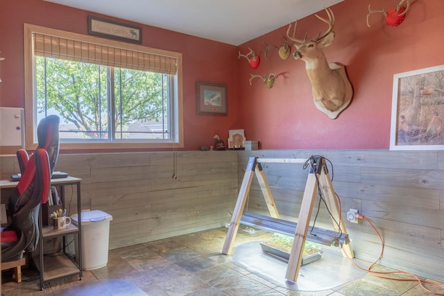recreation room featuring stone finish flooring and an office area