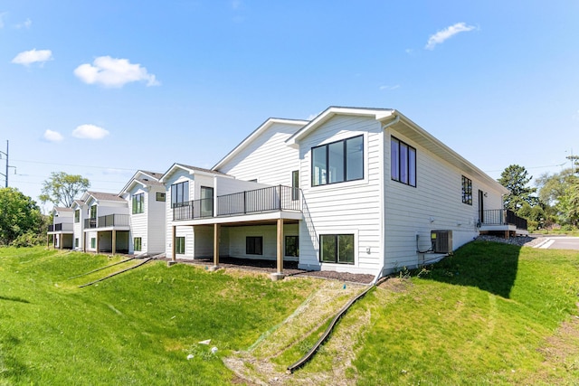 2454 County Road D W, Roseville, MN 55112 - rear view of house featuring a yard, cooling unit, and a deck