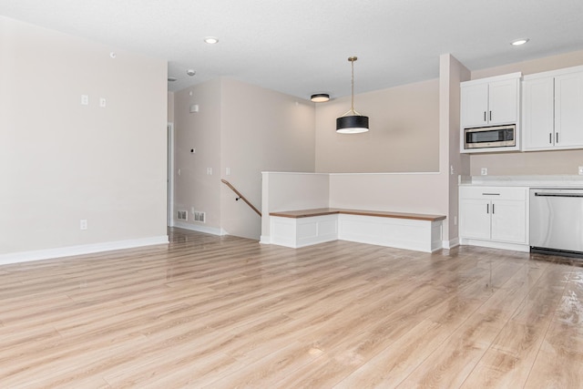 2454 County Road D W, Roseville, MN 55112 - unfurnished living room with light wood-type flooring, recessed lighting, and baseboards