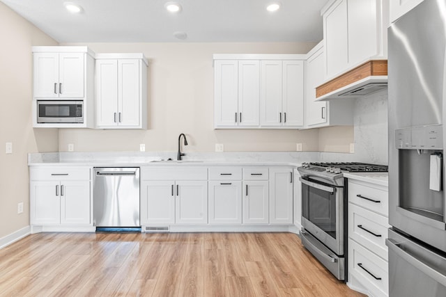 2454 County Road D W, Roseville, MN 55112 - kitchen featuring stainless steel appliances, a sink, light wood-style flooring, white cabinetry, and recessed lighting
