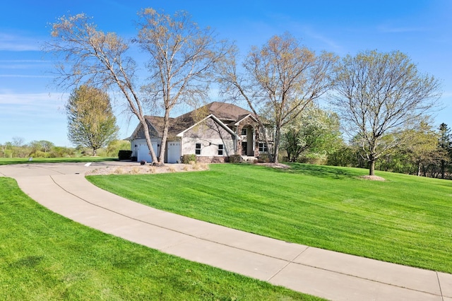14590 Thicket Ln, Dayton, MN 55327 - traditional-style home featuring stone siding, a front yard, driveway, and an attached garage