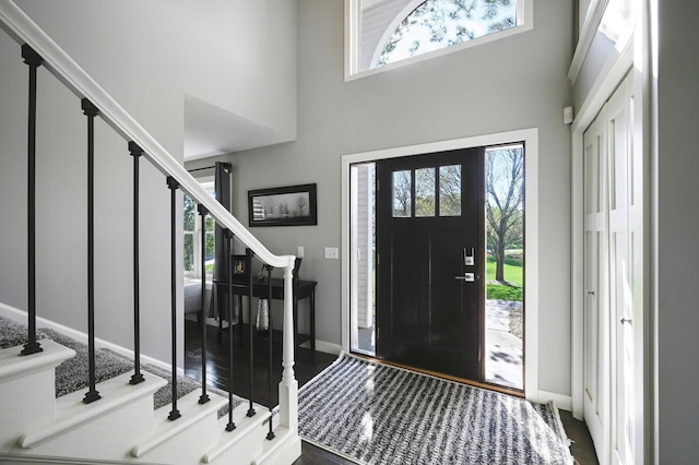 14590 Thicket Ln, Dayton, MN 55327 - entryway featuring stairway, wood finished floors, baseboards, and a high ceiling