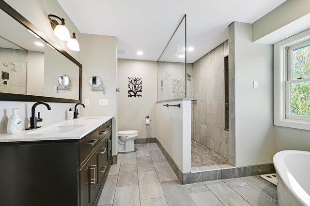 14590 Thicket Ln, Dayton, MN 55327 - full bathroom featuring a freestanding tub, a walk in shower, baseboards, double vanity, and recessed lighting