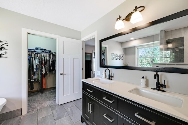 14590 Thicket Ln, Dayton, MN 55327 - bathroom featuring double vanity and a spacious closet
