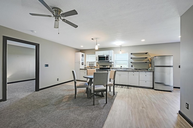 14590 Thicket Ln, Dayton, MN 55327 - dining room featuring a ceiling fan, baseboards, light wood-type flooring, recessed lighting, and a textured ceiling