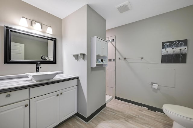 14590 Thicket Ln, Dayton, MN 55327 - bathroom featuring wood finished floors, baseboards, vanity, and a walk in shower