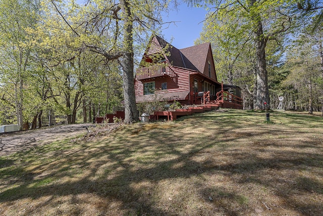 5305 Cisco Ln NE, Remer, MN 56672 - view of home's exterior with faux log siding, a wooden deck, and a lawn