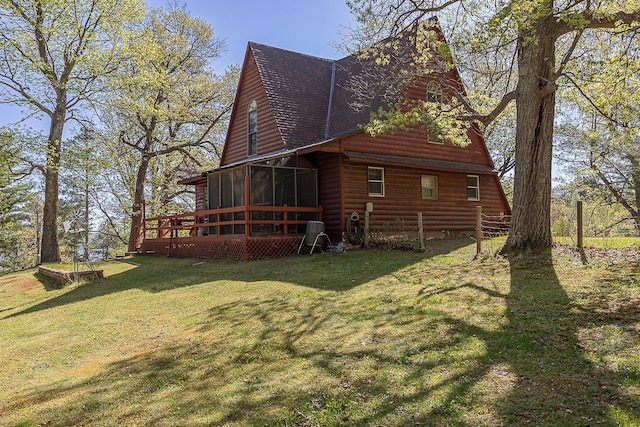 5305 Cisco Ln NE, Remer, MN 56672 - view of side of home with log veneer siding, a sunroom, a shingled roof, a yard, and a wooden deck