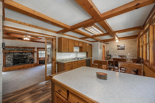 5305 Cisco Ln NE, Remer, MN 56672 - kitchen featuring dark wood-type flooring, stainless steel dishwasher, brown cabinetry, open floor plan, and a ceiling fan