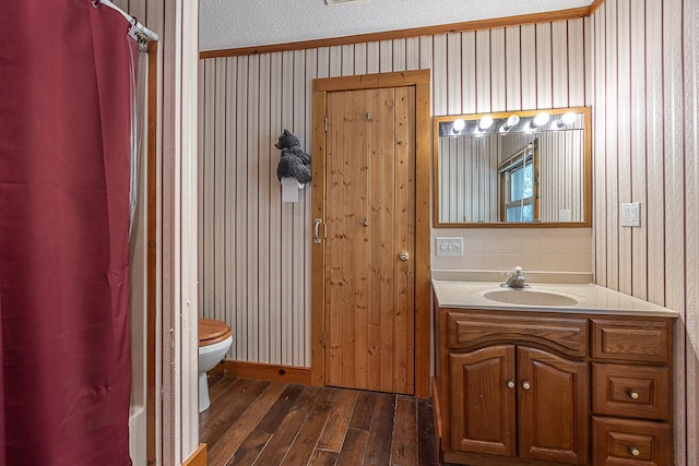 5305 Cisco Ln NE, Remer, MN 56672 - bathroom featuring hardwood / wood-style flooring, toilet, vanity, ornamental molding, and curtained shower