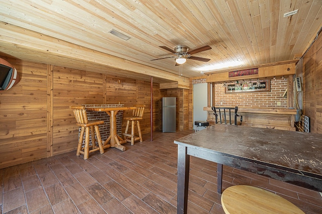 5305 Cisco Ln NE, Remer, MN 56672 - unfurnished dining area featuring wood walls, wooden ceiling, a ceiling fan, wood finished floors, and a bar