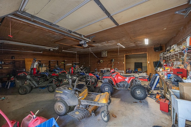5305 Cisco Ln NE, Remer, MN 56672 - garage featuring a workshop area, wooden walls, and a garage door opener