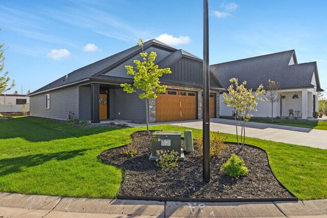 view of front of home featuring concrete driveway, an attached garage, board and batten siding, and a front lawn