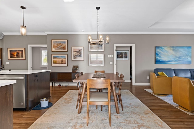 dining space with a chandelier, dark wood-style floors, baseboards, and ornamental molding