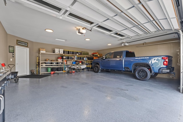 garage featuring a garage door opener and recessed lighting