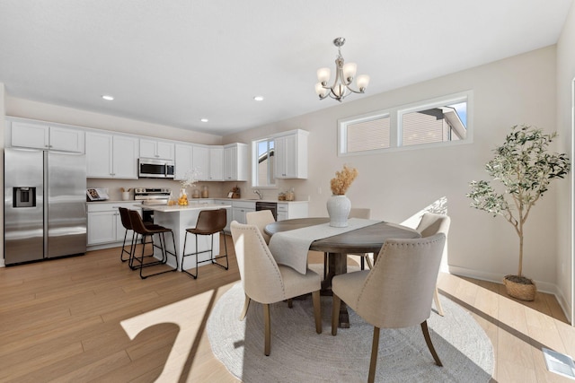 7478 170th Ave NW, Ramsey, MN 55303 - dining room with a chandelier, light wood finished floors, and recessed lighting