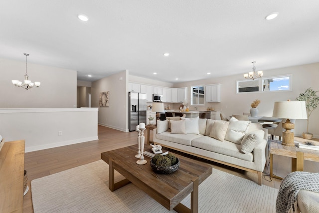 7478 170th Ave NW, Ramsey, MN 55303 - living area featuring a chandelier, light wood-type flooring, baseboards, and recessed lighting